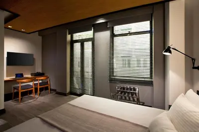 a bedroom with a bed and a desk and a table at MET34 Athens in Athens
