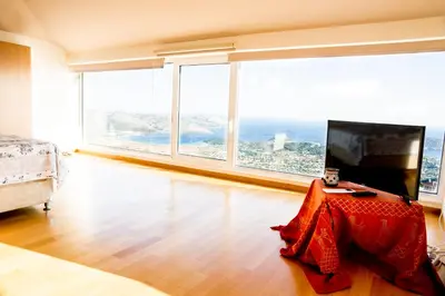 a room with a bed and a television with large windows at Viva B&B in Anavissos