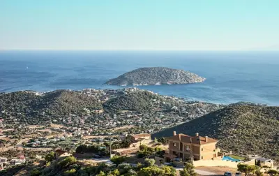 a house on a hill next to the ocean at Viva B&B in Anavissos