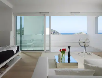 a living room with a couch and a table at Infinity White Complex by GK Properties in Porto Rafti
