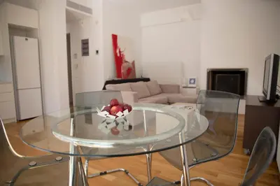 a glass table with a bowl of fruit on top of it at Infinity White Complex by GK Properties in Porto Rafti