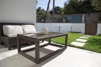a table and a couch on a patio at Infinity White Complex by GK Properties in Porto Rafti