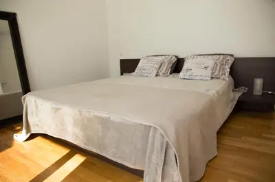 a bedroom with a large bed with two pillows at Infinity White Complex by GK Properties in Porto Rafti