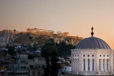 a building with a cross on top of it with a mountain at Villa Brown Ermou, a member of Brown Hotels in Athens