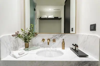 a bathroom with a sink and a mirror at Villa Brown Ermou, a member of Brown Hotels in Athens
