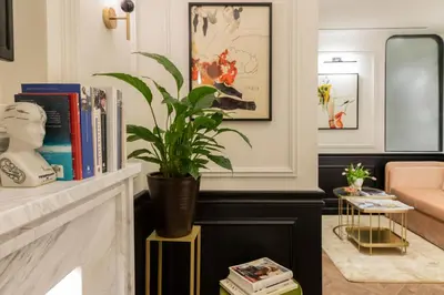 a living room with a potted plant on a fireplace at Villa Brown Ermou, a member of Brown Hotels in Athens