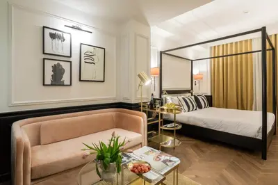 a hotel room with a bed and a couch at Villa Brown Ermou, a member of Brown Hotels in Athens