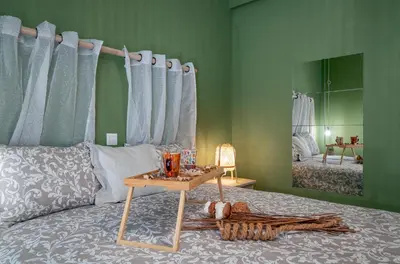 a bedroom with a bed with a table on it at Apartment at the foothills of Acropolis in Athens