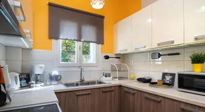 a kitchen with a sink and a microwave at Apartment at the foothills of Acropolis in Athens