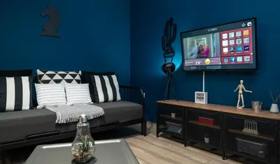 a living room with a couch and a flat screen tv at Apartment at the foothills of Acropolis in Athens