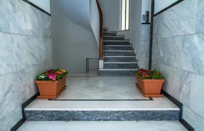 a stairway with two pots of flowers and stairs at Apartment at the foothills of Acropolis in Athens
