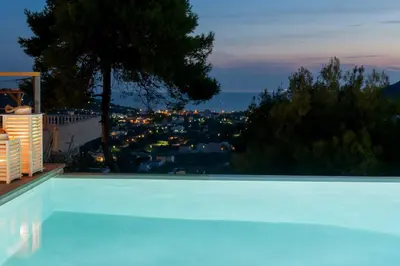 a swimming pool with a view of a city at Joy Villa Agia Marina in Aghia Marina