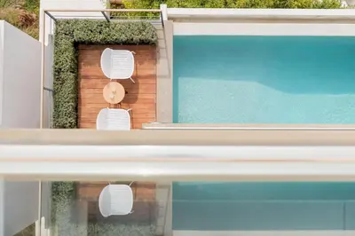 a view of a swimming pool from the window of a house at Joy Villa Agia Marina in Aghia Marina