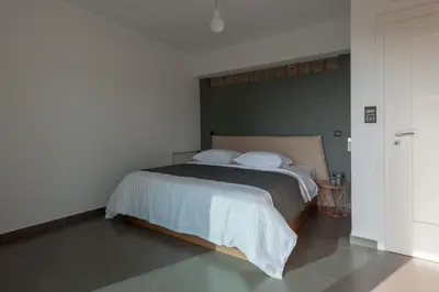 a bedroom with a large bed with two pillows at Joy Villa Agia Marina in Aghia Marina