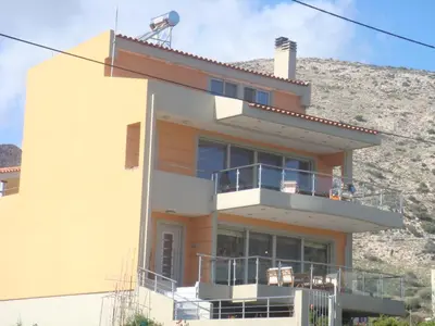 a house with a hill in the background at Sandra's Sea View at Sounio in Sounio
