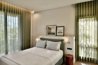 a bedroom with a bed and a large window at KARYATIS LUXURY MAISONETTE by K&K in Athens