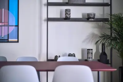 a dining room with a table and white chairs at Kolonaki Boutique Apartments by Olala Homes in Athens