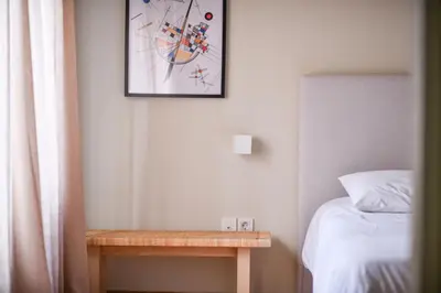 a bedroom with a bed and a picture on the wall at Kolonaki Boutique Apartments by Olala Homes in Athens
