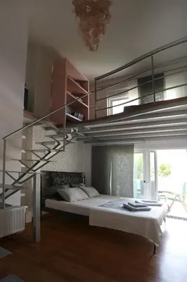 a bedroom with a bed with a metal staircase at Thimari Sports & Spa with private pool and jacuzzi in Sounio