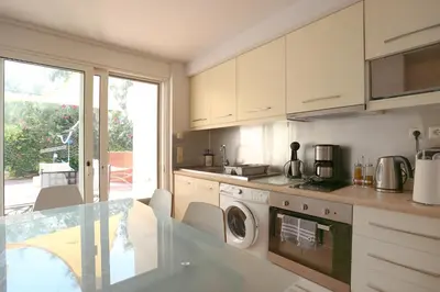 a kitchen with a washer and dryer in it at Thimari Sports & Spa with private pool and jacuzzi in Sounio