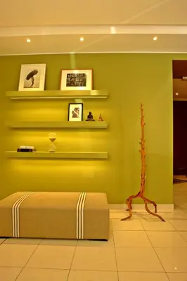 a bedroom with a green wall with a bed at Semeli Hotel in Athens