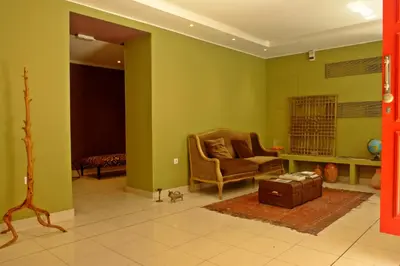 a living room with green walls and a chair at Semeli Hotel in Athens