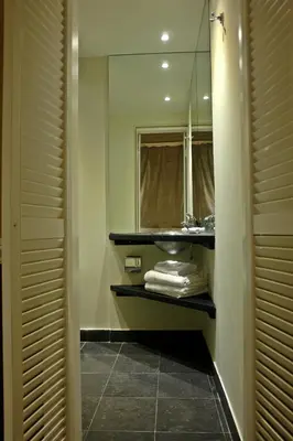 a bathroom with a sink and a mirror at Semeli Hotel in Athens