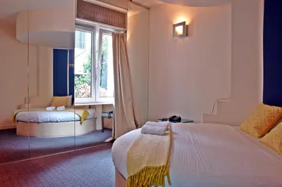a hotel room with a bed and a window at Semeli Hotel in Athens