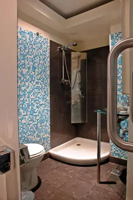 a bathroom with a shower and a toilet and a tub at Semeli Hotel in Athens