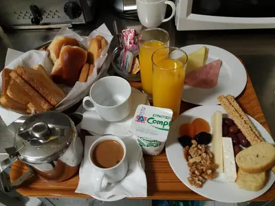 a table topped with plates of breakfast foods and drinks at Semeli Hotel in Athens