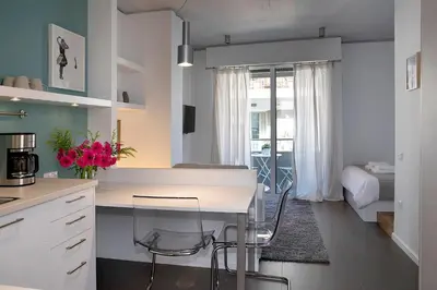 a kitchen with a table and chairs in a room at Homz Studios Neapolis in Athens