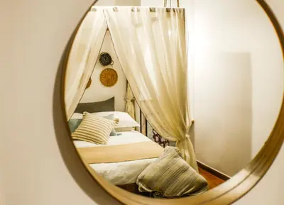 a mirror reflection of a bedroom with a bed at 5inAthens in Athens