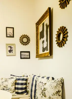 a living room with a couch and some pictures on the wall at 5inAthens in Athens