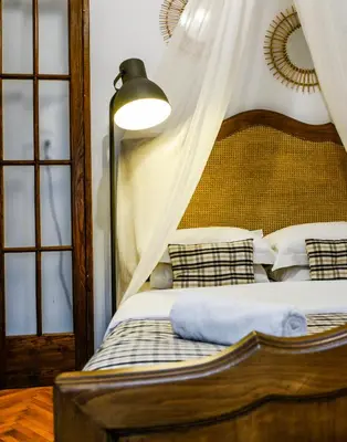 a bedroom with a canopy bed with pillows at 5inAthens in Athens