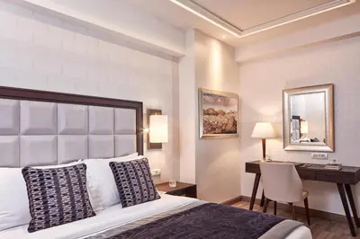 a hotel room with a bed and a desk at Electra Metropolis in Athens