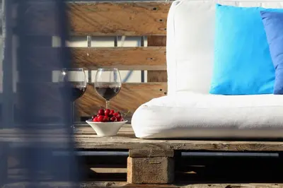 a table with two glasses of wine and a bowl of fruit at Live in Athens, THISEIO Residency, Our first love #01 in Athens