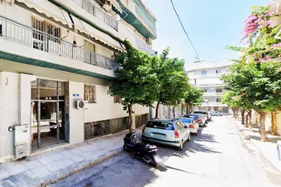 a scooter parked on a street next to a building at Live in Athens, THISEIO Residency, Our first love #01 in Athens