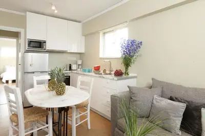 a kitchen and living room with a table and a couch at Live in Athens, THISEIO Residency, Our first love #01 in Athens