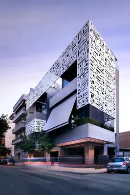 a tall building with a white facade on a street at Athina Art Apartments in Athens
