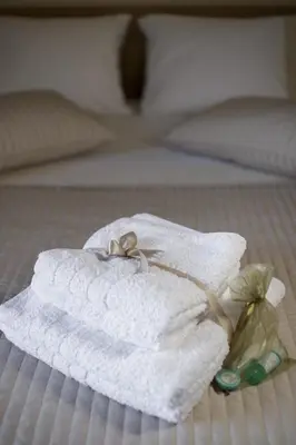 a white towel with a pair of wedding rings on it at Dimitris Home in Athens