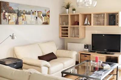 a living room with a couch and a tv at Dimitris Home in Athens