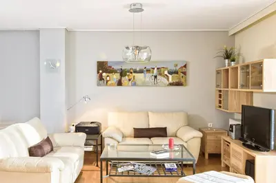 a living room with a couch and a tv at Dimitris Home in Athens