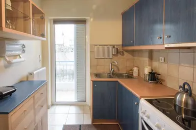 a kitchen with blue cabinets and a sink at Dimitris Home in Athens