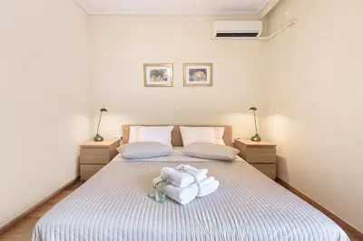 a bedroom with a bed with towels on it at Dimitris Home in Athens