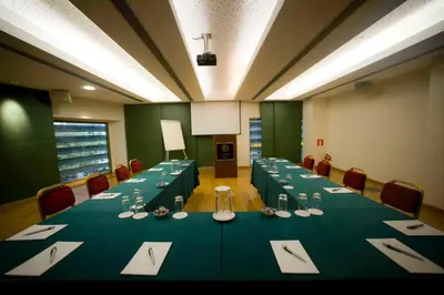 a large conference room with a long table with chairs at Athinais Hotel in Athens