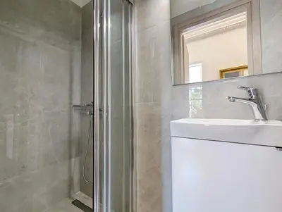 a bathroom with a shower and a sink and a mirror at Acropolis View Dream Apartments in Athens