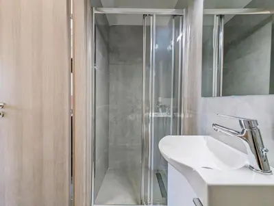 a bathroom with a glass shower and a sink at Acropolis View Dream Apartments in Athens