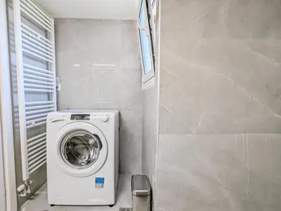 a small bathroom with a washing machine in it at Acropolis View Dream Apartments in Athens