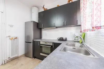 a kitchen with a sink and a stainless steel refrigerator at Acropolis View Dream Apartments in Athens