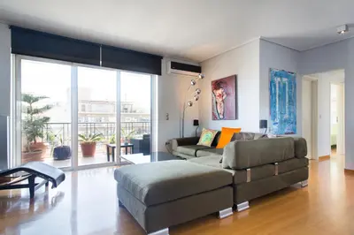 a living room with a couch and a table at Acropolis Tony's Penthouse in Athens